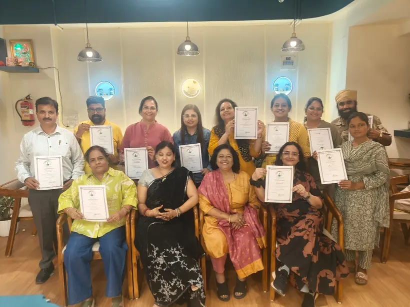 Workshop participants holding certificates with Dr. Abha Jain